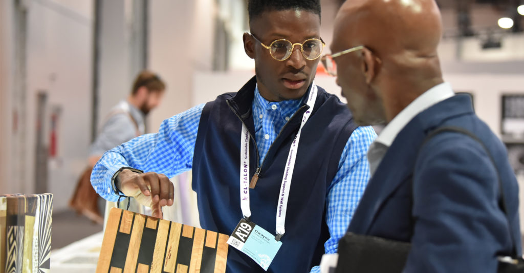 Exhibitor talking to attendee