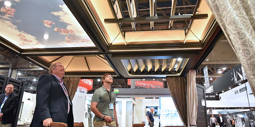 Exhibitor showing attendee ceiling samples