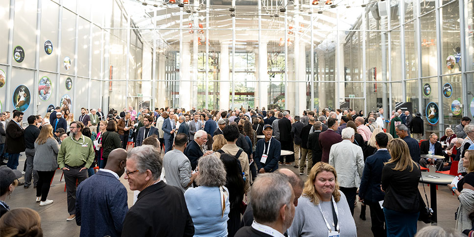 Attendees networking at a party at the AIA Conference on Architecture and Design.