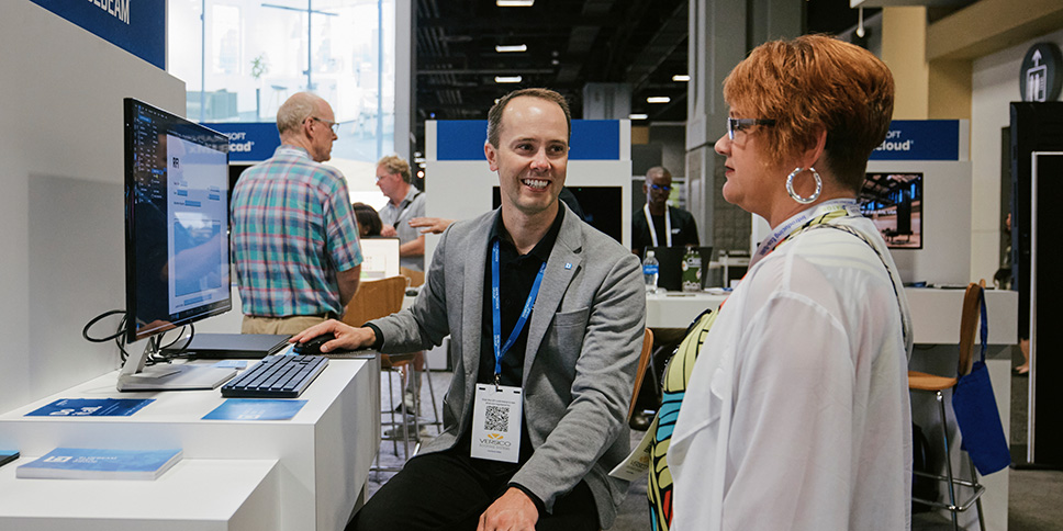 Conference exhibitor talking with attendee