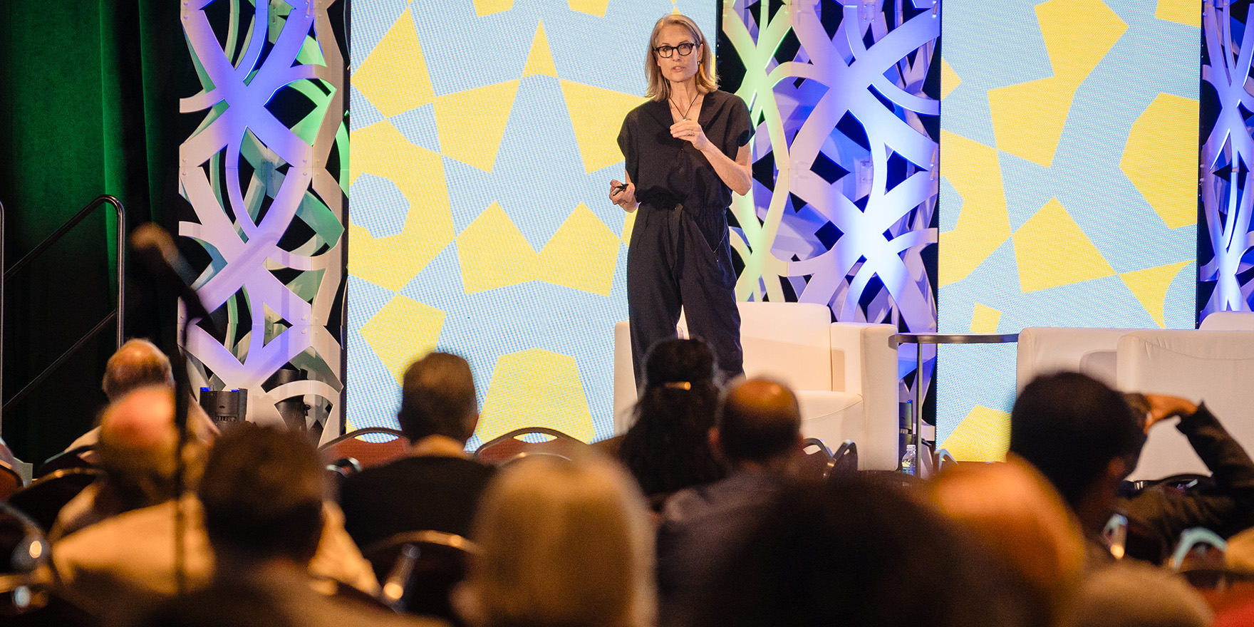 A woman leading an education session at conference.