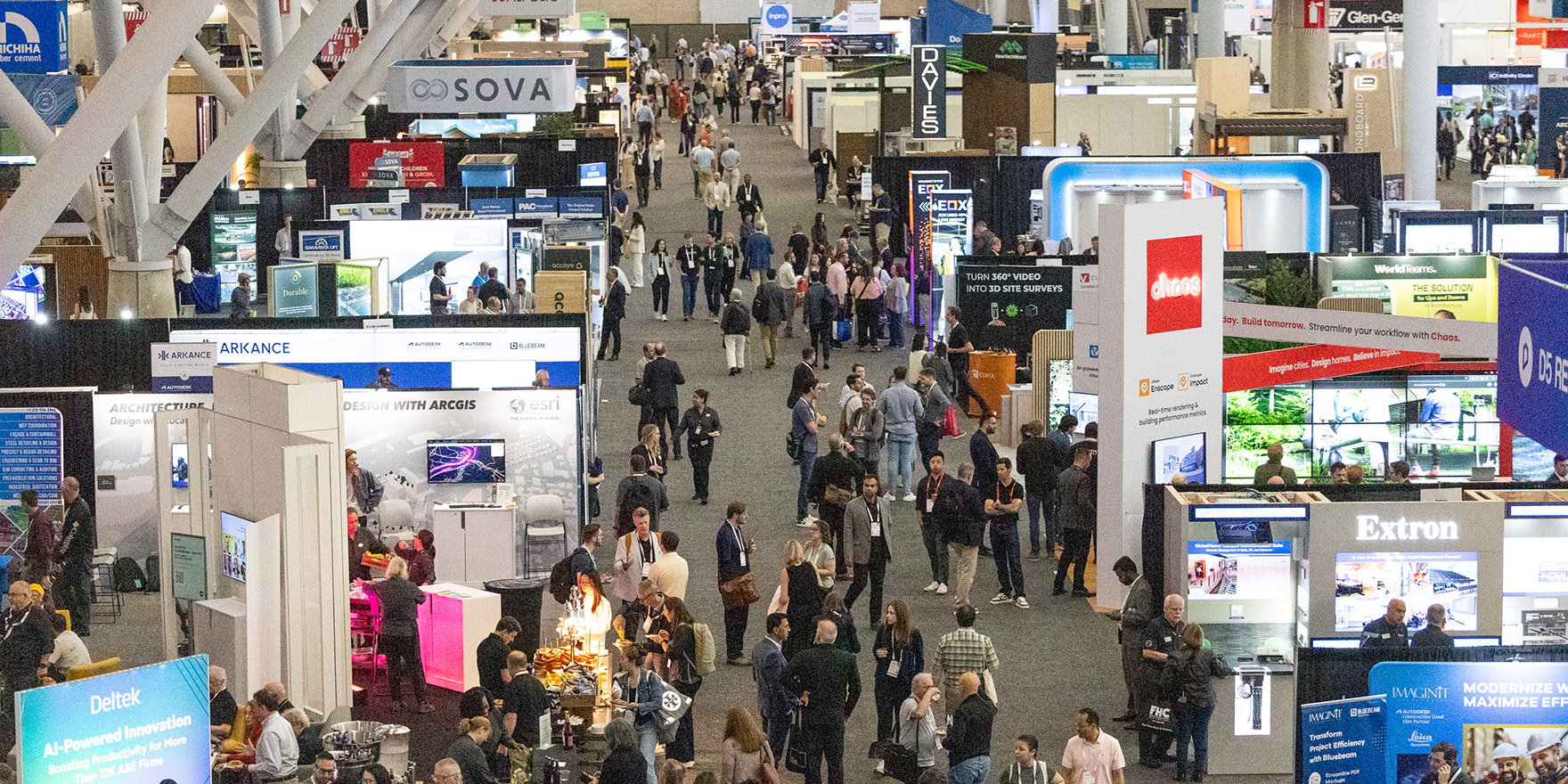 Crowd of people visiting booths and networking at the conference on architecture and design.