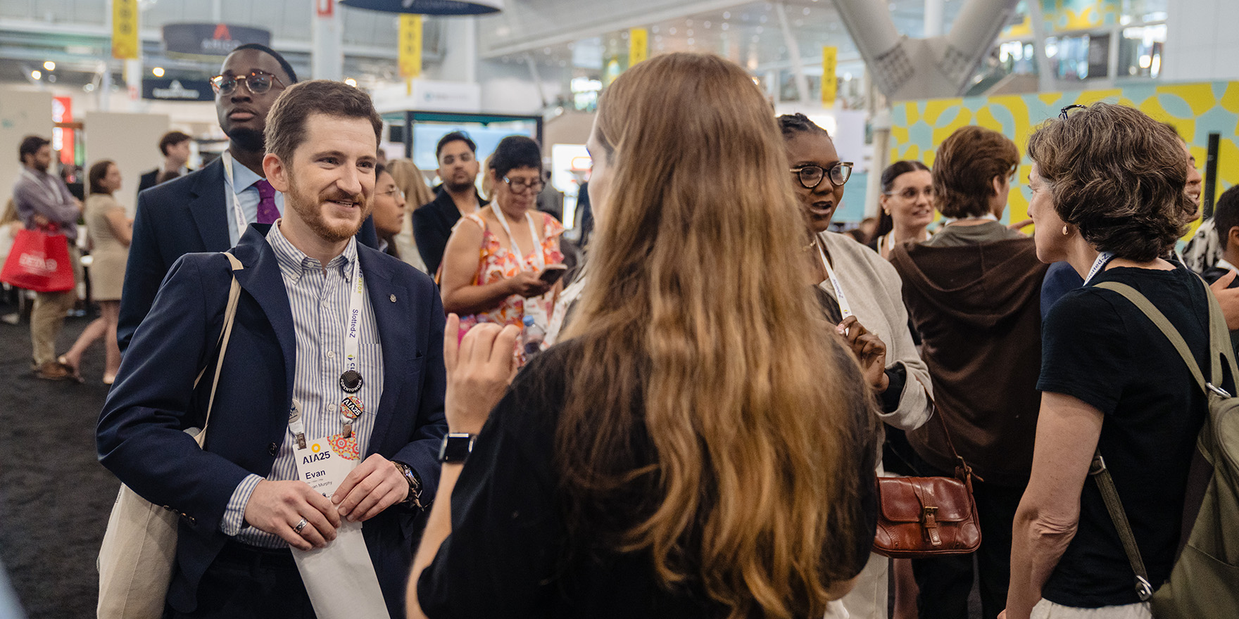 Two attendees networking at the conference on architecture and design.