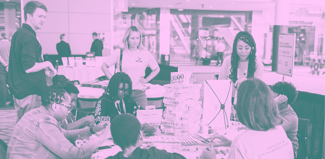 Group of attendees doing community service, stuffing gift boxes.