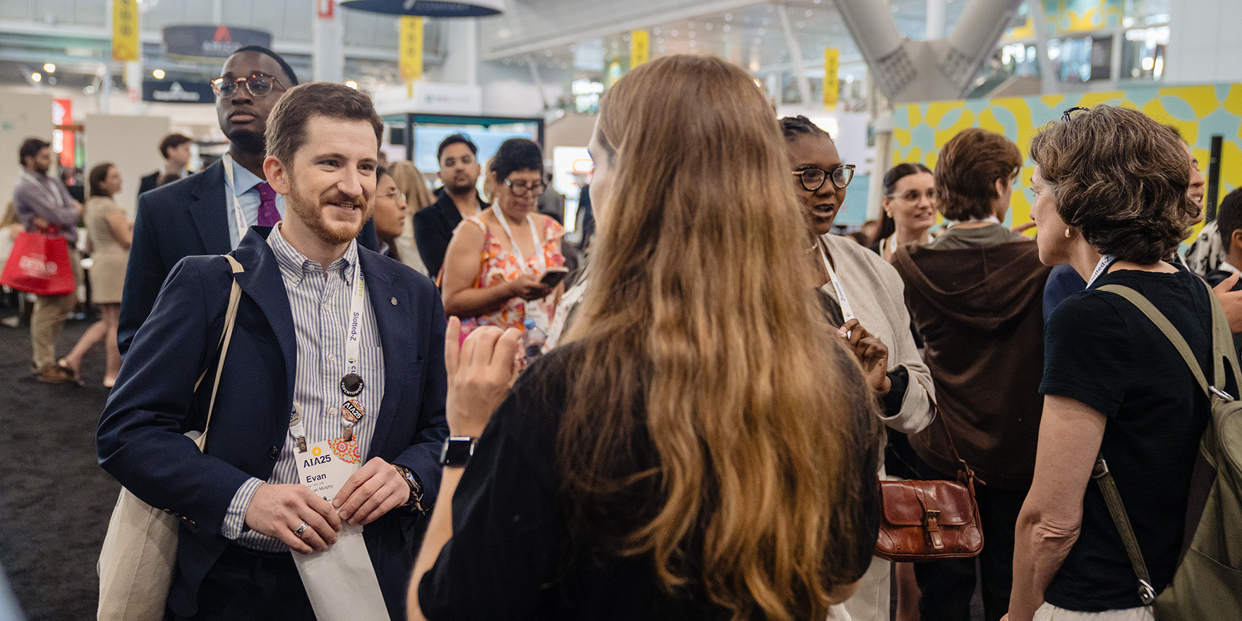 Conference attendees connecting, learning, and networking with peers, experts, and exhibitors.