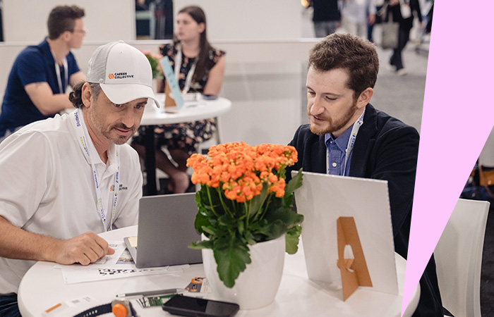Two individuals at a conference talking about sustainability and wellness